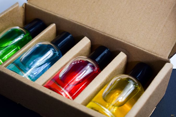 Four different perfume bottles in a cardboard box