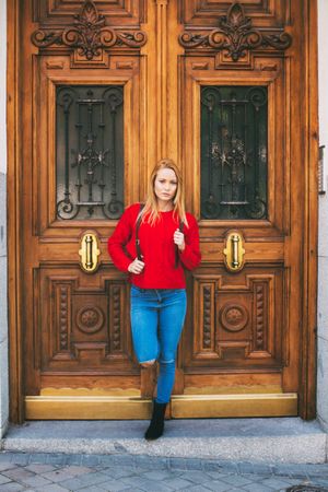 Confident woman near ornamental wall