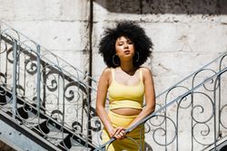 Stylish female leaning on railing outdoors