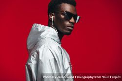 Trendy young man against red background 0W97O4