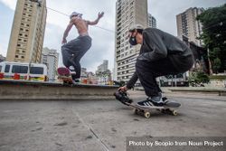 Two men with facemasks on skateboard 4jMNz5