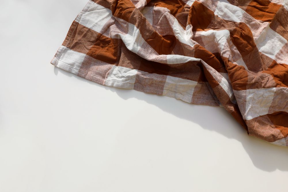 Overhead shot of rusty brown checkered table cloth