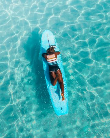 Top view of woman on surfboard