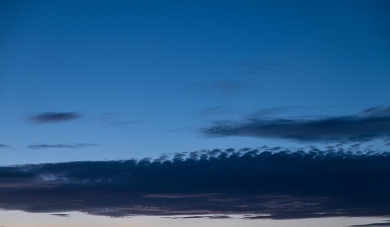 Darker clouds in a an evening blue sky
