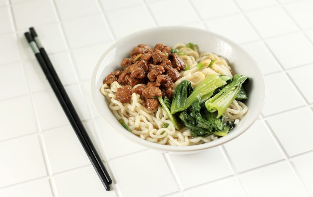 Asian egg chicken noodle soup with pak choy