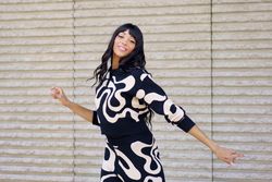 Passionate dancer smiling at camera while performing in the city