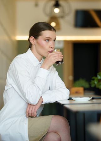 Woman sipping cold brew in restaurant