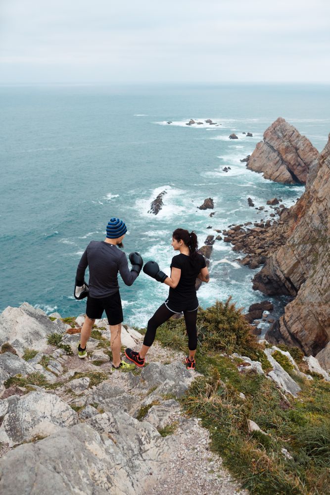Boxers exercising on cliff