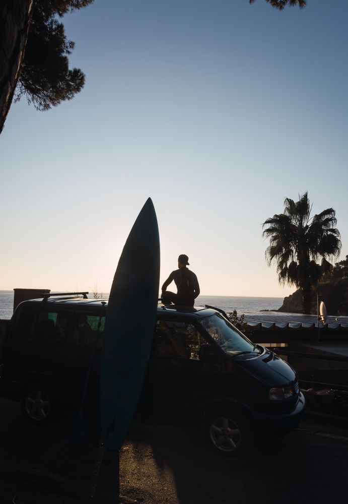 Man enjoying the sunrise in his camped van