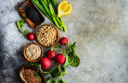Fresh ingredients of radishes, lemon slices and chick peas with copy space
