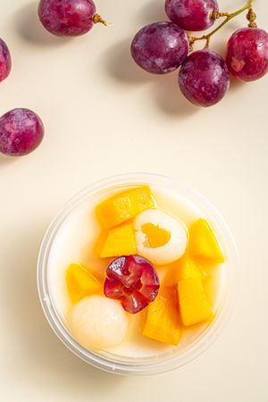 Three bowls of pudding fruit with a flower like shape from grape