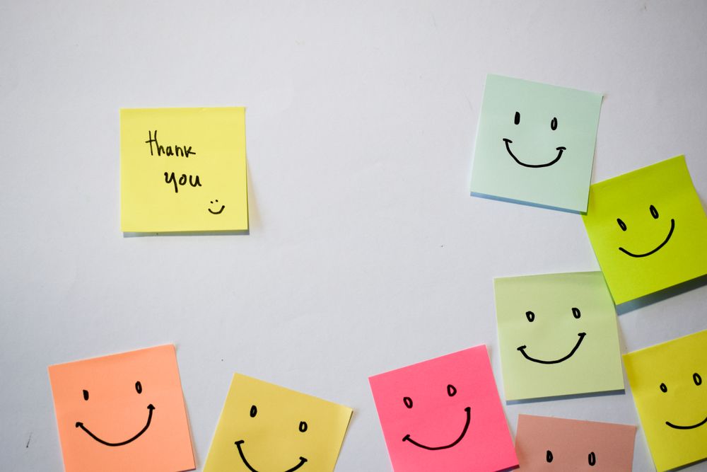 Thank you and smile emoticon on sticky notes