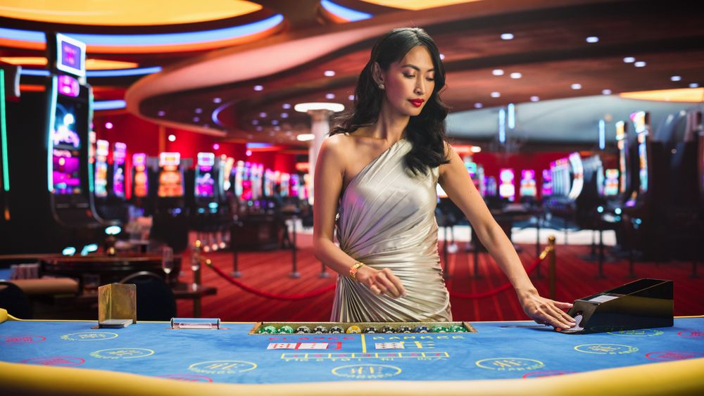 Card Dealer Looking at the Camera and Revealing Possibly Winning Combination.