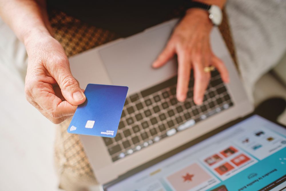 Online shopping with business debit card on laptop