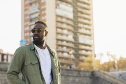 handsome and attractive Black man with sunglasses. reflects of sunlight
