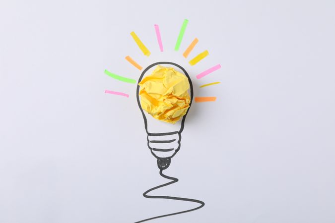 Drawn light bulb and paper ball on light background. Good idea concept