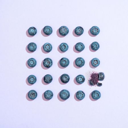 Row of blueberries on purple background