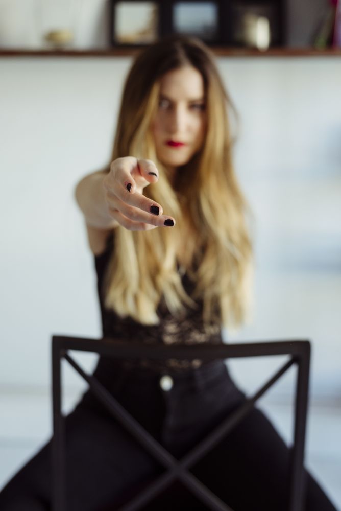 woman in bra sitting on chair