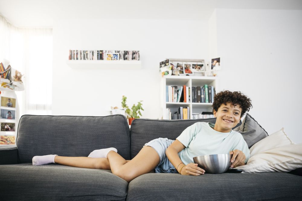 Girl watching tv in living room