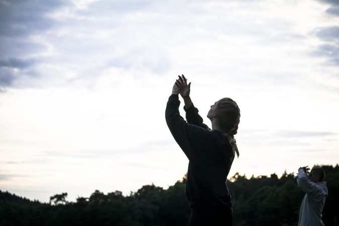Woman meditating during sunset in nature
