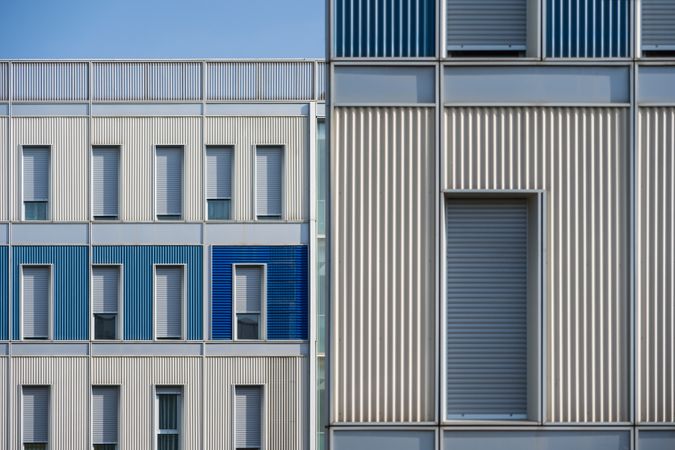 Facade of modern multicolored building with narrow windows