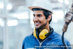 Portrait of smiling industrial engineer worker wearing safety helmet 41YRl4