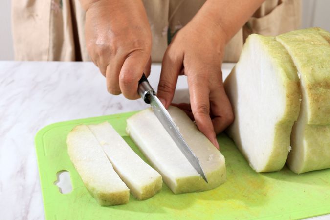 Female Hand Slicing Lontong, Indonesian Compressed Rice Cake