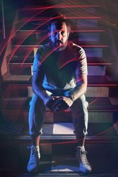 Man sitting on stairs in nightclub