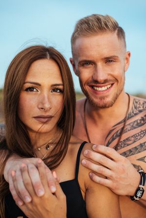 Cool dreamy couple in swimwear on shore