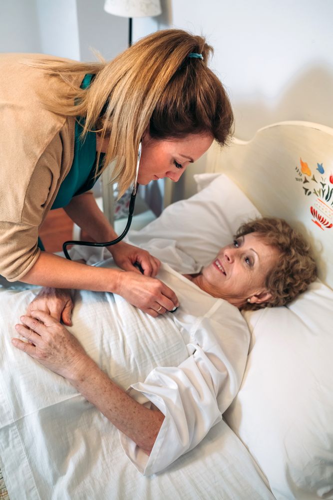 Caregiver auscultating woman