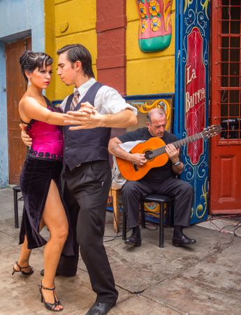 Buenos Aires, Argentina February, 01 2014: Couple dancing on street to guitar music