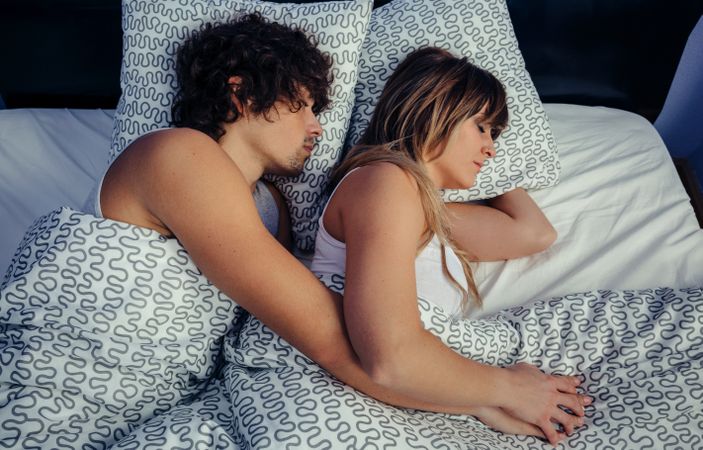 Couple sleeping together in bed