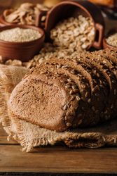 Freshly baked rye bread on napkin on table