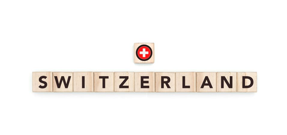 Wooden blocks bearing the name and flag of Switzerland. Swiss and European Culture, national identity, travel, and geography in a copy space design.