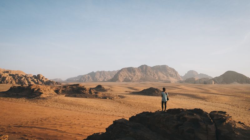 Anonymous woman standing in rocky terrain