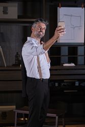 Mature elegant businessman taking selfie in wardrobe