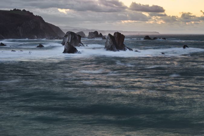 Storm with blustering waves on rocky coast