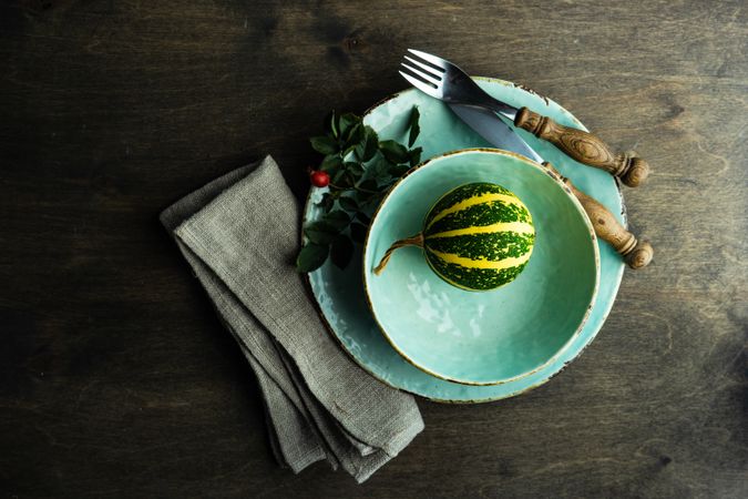 Thanksgiving table setting with squash in light blue bowl