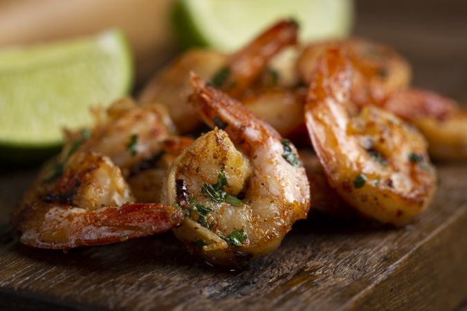 Delicious grilled prawns on wooden background.