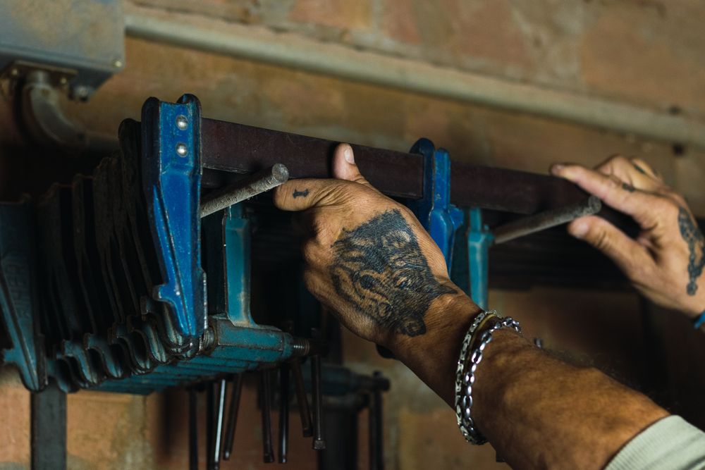 Anonymous man using carpentry tool in workshop