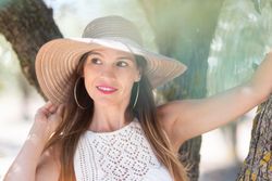 Adult woman standing near tree