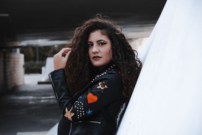 Young woman in rocker outfit looking at camera