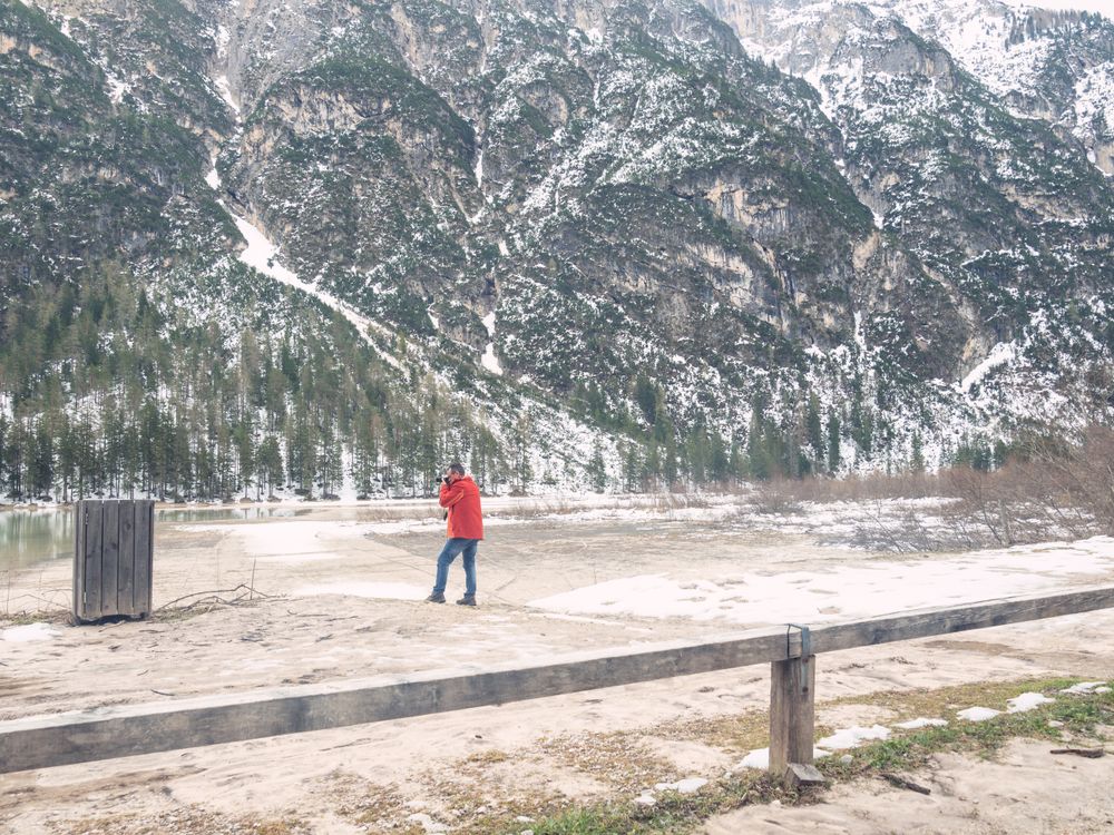 Man standing and taking photo of rocky landscape