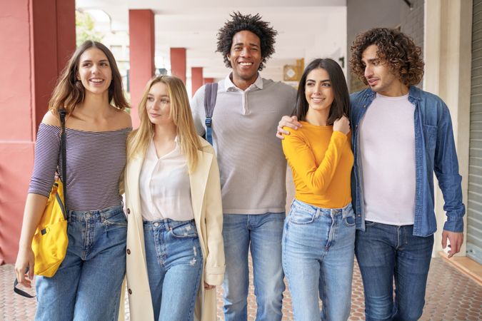 Group of friends strolling down the street outside