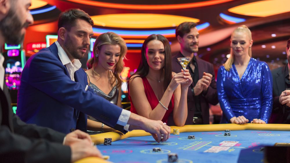 Happy and Cheerful Group of Casino Guests Placing Bets and Celebrating Winning Luck and Skill in Baccarat.