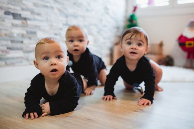 Happy babies sitting on floor