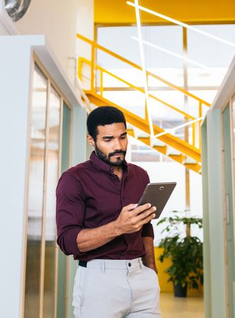 Handsome Latino man working with a tablet in a coworking