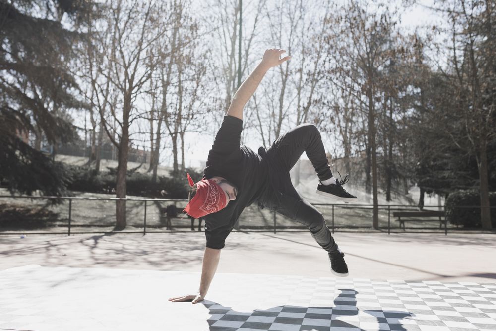 Man dancing break dance in park