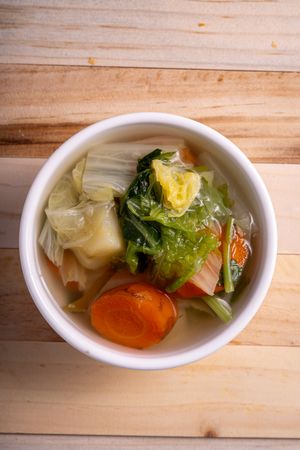A bowl of soup with vegetables in it