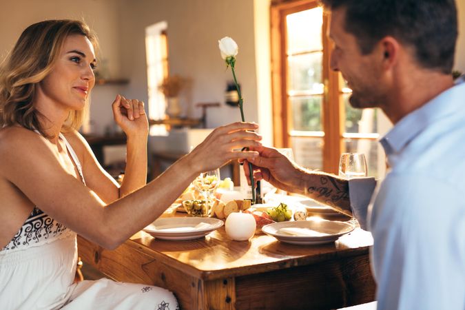 Romantic couple sitting at dining table at home